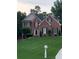 Charming brick home with a well-manicured lawn and classic architectural details at 1502 La Fayette Pl, Loganville, GA 30052