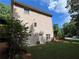 Side view of home with finished basement, well-manicured lawn and mature trees at 1502 La Fayette Pl, Loganville, GA 30052