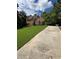 Two-story brick home offers great curb appeal with a long drive, mature trees and a lush green lawn at 1502 La Fayette Pl, Loganville, GA 30052