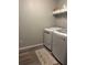 Clean laundry room with modern washer and dryer, plus convenient shelf storage at 1502 La Fayette Pl, Loganville, GA 30052