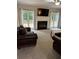 Cozy living room with a fireplace, comfortable seating, and natural light at 1502 La Fayette Pl, Loganville, GA 30052