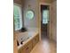 Inviting bathroom featuring a soaking tub, marble tile, and a window at 1502 La Fayette Pl, Loganville, GA 30052