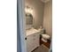 Charming powder room with white vanity, marble countertop and classic fixtures at 1502 La Fayette Pl, Loganville, GA 30052