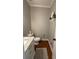 Simple powder room featuring white vanity, neutral paint and hardwood floors at 1502 La Fayette Pl, Loganville, GA 30052