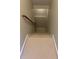 Carpeted basement staircase with wood handrail at 1502 La Fayette Pl, Loganville, GA 30052