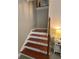 A well-lit stairway with hardwood steps and a light-colored wall at 1502 La Fayette Pl, Loganville, GA 30052