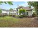 Backyard view showing the landscaping and rear of home, featuring many windows at 1996 Wellesley Trce, Atlanta, GA 30338