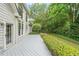 Back exterior with large windows, a porch, and a landscaped backyard at 1996 Wellesley Trce, Atlanta, GA 30338