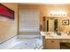 Bathroom featuring a soaking tub, double sinks, and decorative lighting at 1996 Wellesley Trce, Atlanta, GA 30338