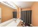 Hall bathroom with a single sink and a shower tub and a patterned tile floor at 1996 Wellesley Trce, Atlanta, GA 30338