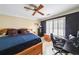 Comfortable bedroom with modern decor, a ceiling fan, and a dedicated workspace at 1996 Wellesley Trce, Atlanta, GA 30338