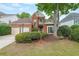 Charming brick home featuring a two-car garage, well-maintained landscaping, and traditional architectural details at 1996 Wellesley Trce, Atlanta, GA 30338