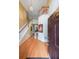 Bright, two-story foyer with hardwood floors, a staircase with white railings, and a modern chandelier at 1996 Wellesley Trce, Atlanta, GA 30338