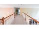 Upstairs hallway featuring neutral carpets and wood and white railings at 1996 Wellesley Trce, Atlanta, GA 30338