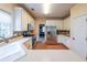 Bright eat-in kitchen features white cabinets, stainless appliances and tiled backsplash at 1996 Wellesley Trce, Atlanta, GA 30338