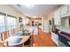 Eat-in kitchen featuring a window, stainless appliances, white cabinets, and wooden floors at 1996 Wellesley Trce, Atlanta, GA 30338