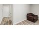 Finished basement featuring a leather chair, door and laminate flooring at 2025 Venetian Sw Dr, Atlanta, GA 30311