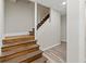 Basement access stairs with wooden treads, painted risers and laminate flooring at 2025 Venetian Sw Dr, Atlanta, GA 30311