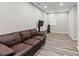 Finished basement featuring a leather couch, tv stand, chair and an egress window at 2025 Venetian Sw Dr, Atlanta, GA 30311