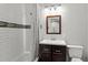 Bathroom with a shower, tiled walls, vanity and framed mirror at 2025 Venetian Sw Dr, Atlanta, GA 30311