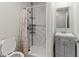 Bathroom with a shower, marble style walls and a gray vanity with sink at 2025 Venetian Sw Dr, Atlanta, GA 30311