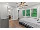 Cozy bedroom features hardwood floors, large windows, and ensuite bathroom at 2025 Venetian Sw Dr, Atlanta, GA 30311