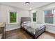Light-filled bedroom with hardwood floors and views of the trees outside the windows at 2025 Venetian Sw Dr, Atlanta, GA 30311