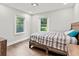 Stylish bedroom with hardwood floors, a comfortable bed, and natural light at 2025 Venetian Sw Dr, Atlanta, GA 30311