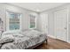 Spacious bedroom with hardwood floors, natural lighting, and two windows overlooking the backyard at 2025 Venetian Sw Dr, Atlanta, GA 30311