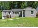 Charming single-story home with gray brick and siding, complemented by a lush green lawn at 2025 Venetian Sw Dr, Atlanta, GA 30311