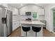 Modern kitchen with stainless steel appliances, white cabinets, and island with seating at 2025 Venetian Sw Dr, Atlanta, GA 30311