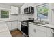 Bright kitchen with white cabinetry, stainless steel appliances and granite countertops at 2025 Venetian Sw Dr, Atlanta, GA 30311