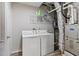 Laundry room featuring a washer and dryer with shelving above for storage space at 2025 Venetian Sw Dr, Atlanta, GA 30311