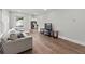 Bright living room featuring hardwood floors, a comfortable sofa, and large windows at 2025 Venetian Sw Dr, Atlanta, GA 30311