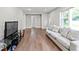 Cozy living room featuring hardwood floors, a comfortable sofa, and plenty of natural light at 2025 Venetian Sw Dr, Atlanta, GA 30311
