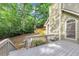 Backyard view featuring a deck with stairs, mature trees and landscaping at 284 Due West Ct, Dallas, GA 30157