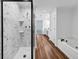Bathroom showcases a modern shower, soaking tub, wood grain floors and granite counters at 284 Due West Ct, Dallas, GA 30157