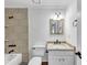 Updated bathroom featuring tiled walls, modern fixtures, and a granite vanity at 284 Due West Ct, Dallas, GA 30157