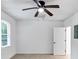 Neutral bedroom featuring tile floors, a ceiling fan, and a window letting in natural light at 284 Due West Ct, Dallas, GA 30157