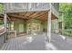 Exterior view of a home with a wooden deck with covered area and view of wooded landscape at 284 Due West Ct, Dallas, GA 30157