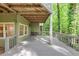Exterior view of a house with a large wooden deck and view of the surrounding wooded area at 284 Due West Ct, Dallas, GA 30157