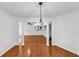 Bright dining room featuring hardwood floors, chair rail molding, and an elegant chandelier at 284 Due West Ct, Dallas, GA 30157