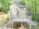Multi-level home featuring a deck, with stairs, nestled among trees on a sloped lot at 284 Due West Ct, Dallas, GA 30157