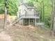 Multi-level home featuring a deck, with stairs, nestled among trees on a sloped lot at 284 Due West Ct, Dallas, GA 30157