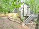 Multi-level home featuring a deck, with stairs, nestled among trees on a sloped lot at 284 Due West Ct, Dallas, GA 30157