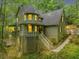 Charming two-story home with a unique turret and welcoming front porch surrounded by lush greenery at 284 Due West Ct, Dallas, GA 30157