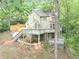 Multi-level home featuring a deck, with stairs, nestled among trees on a sloped lot at 284 Due West Ct, Dallas, GA 30157