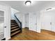 Elegant foyer with hardwood floors, a black staircase, and multiple white doors leading to various rooms at 284 Due West Ct, Dallas, GA 30157