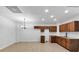 Kitchen area with tile floor, wooden cabinets, sink, and a decorative hanging light fixture at 284 Due West Ct, Dallas, GA 30157