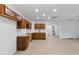 Open kitchen area with tile floor, wooden cabinets, sink, and a door leading to a bathroom at 284 Due West Ct, Dallas, GA 30157